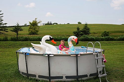 09072024
Six-year-old Penelope Reilly-Brady floats on an inflatable flamingo in her family&#x2019;s above-ground pool at their home northwest of Alexander on a hot Tuesday afternoon. (Tim Smith/The Brandon Sun)