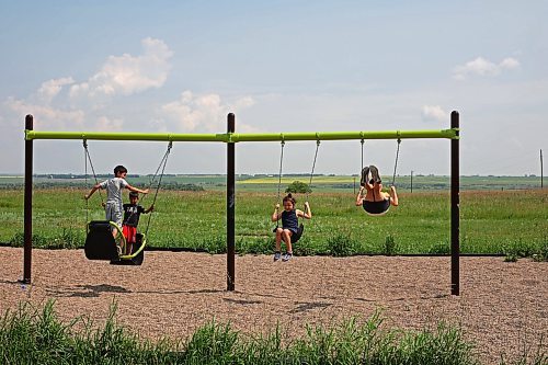 09072024
Kids play on a set of swings overlooking the prairie in the Assiniboine River valley at Sioux Valley Dakota Nation on a hot Tuesday afternoon. (Tim Smith/The Brandon Sun)