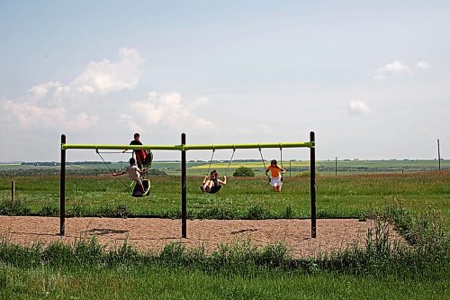 09072024
Kids play on a set of swings overlooking the prairie in the Assiniboine River valley at Sioux Valley Dakota Nation on a hot Tuesday afternoon. (Tim Smith/The Brandon Sun)