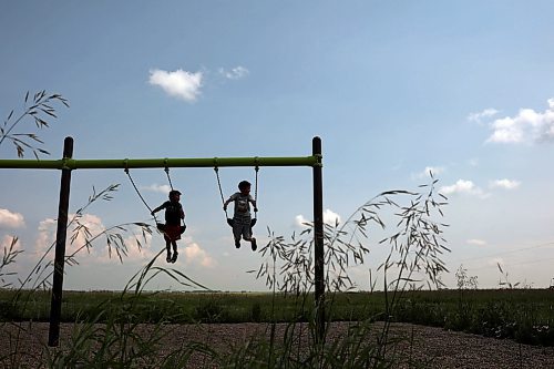 09072024
Kids play on a set of swings overlooking the prairie in the Assiniboine River valley at Sioux Valley Dakota Nation on a hot Tuesday afternoon. (Tim Smith/The Brandon Sun)