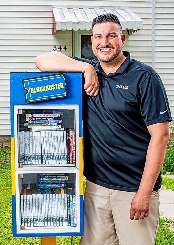 NIC ADAM / FREE PRESS
AJ Ongenae pictured alongside the Blockbuster themed little library on the front lawn of his Rossmere home.
240709 - Tuesday, July 09, 2024.

Reporter: Jura