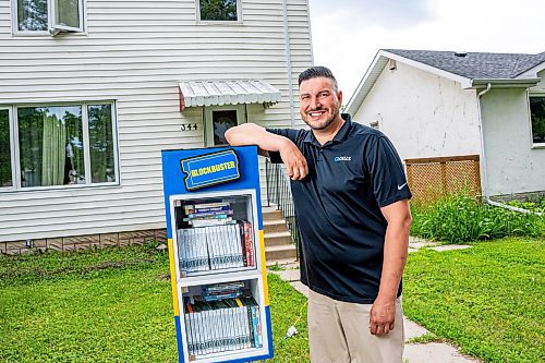 NIC ADAM / FREE PRESS
AJ Ongenae pictured alongside the Blockbuster themed little library on the front lawn of his Rossmere home.
240709 - Tuesday, July 09, 2024.

Reporter: Jura