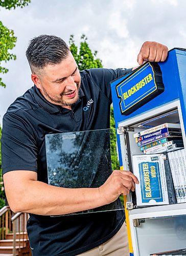 NIC ADAM / FREE PRESS
AJ Ongenae pictured alongside the Blockbuster themed little library on the front lawn of his Rossmere home.
240709 - Tuesday, July 09, 2024.

Reporter: Jura