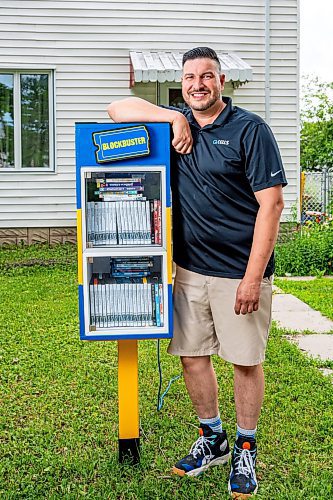 NIC ADAM / FREE PRESS
AJ Ongenae pictured alongside the Blockbuster themed little library on the front lawn of his Rossmere home.
240709 - Tuesday, July 09, 2024.

Reporter: Jura