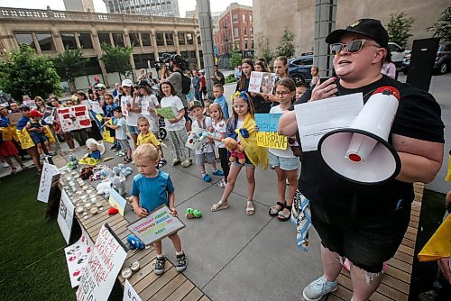 JOHN WOODS / FREE PRESS
Mariana Sklepowich, MC, speaks to Ukraine supporters gather at the corner of portage and Notre Dame for a rally in Winnipeg Tuesday, July 9, 2024. 

Reporter: ?