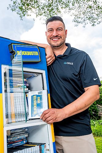 NIC ADAM / FREE PRESS
AJ Ongenae pictured alongside the Blockbuster themed little library on the front lawn of his Rossmere home.
240709 - Tuesday, July 09, 2024.

Reporter: Jura