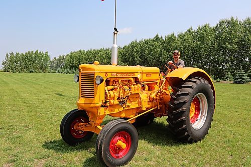 Mark Phillips drives his restored 1955 U-Diesel tractor on Wednesday afternoon in his field at Forrest. (Abiola Odutola/The Brandon Sun)