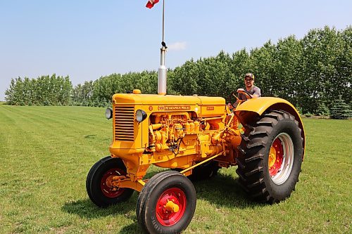 Mark Phillips drives his restored 1955 U-Diesel tractor on Wednesday afternoon in his field at Forrest. (Abiola Odutola/The Brandon Sun)