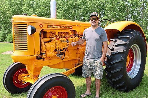 Mark Phillips stands by his restored 1955 U-Diesel tractor on Wednesday afternoon in his field at Forrest. (Abiola Odutola/The Brandon Sun)