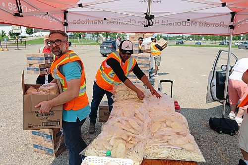 Volunteers from Heritage Co-op, McCain Foods and Ronald McDonald House Charities grab bags of frozen fries and hashbrowns to hand out in exchange for donations at the annual Free Fry Day fundraiser at the Keystone Centre on Wednesday. (Colin Slark/The Brandon Sun)