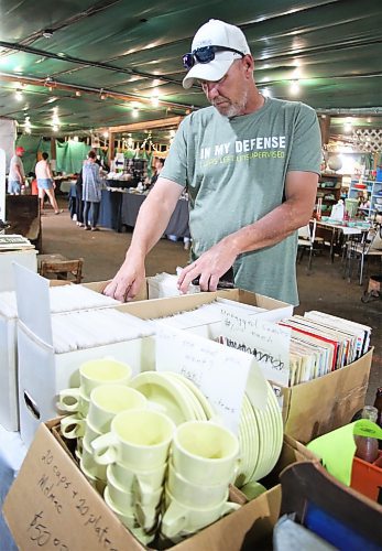 Cliff Bassett flips through some sealed comic books at the Southview Flea Market on Saturday.  (Photos by Karen McKinley/The Brandon Sun)