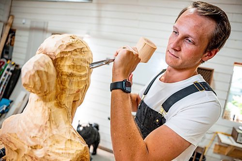 NIC ADAM / FREE PRESS
Wood carver Lucas Kost, 28, in his home-garage studio on Wednesday morning.
240710 - Wednesday, July 10, 2024.

Reporter: Dave