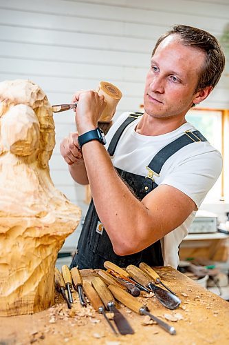 NIC ADAM / FREE PRESS
Wood carver Lucas Kost, 28, in his home-garage studio on Wednesday morning.
240710 - Wednesday, July 10, 2024.

Reporter: Dave