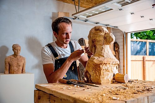 NIC ADAM / FREE PRESS
Wood carver Lucas Kost, 28, in his home-garage studio on Wednesday morning.
240710 - Wednesday, July 10, 2024.

Reporter: Dave