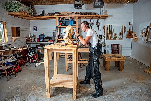 NIC ADAM / FREE PRESS
Wood carver Lucas Kost, 28, in his home-garage studio on Wednesday morning.
240710 - Wednesday, July 10, 2024.

Reporter: Dave