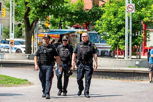 MIKAELA MACKENZIE / FREE PRESS

Foot patrol officers Stephen Desrochers (left), John Middleton, and Todd Martens (who part of the Violent Crime Retail Theft Initiative) walk through Old Market Square in the Exchange District on Wednesday, July 10, 2024. 

For Chris story.

