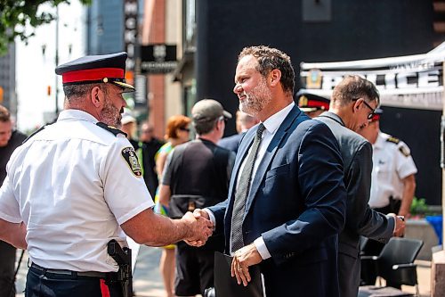 MIKAELA MACKENZIE / FREE PRESS

Justice minister Matt Wiebe (right) shakes hands with WPS inspector Eric Luke after an press conference about the Violent Crime Retail Theft Initiative at Bijou Park on Wednesday, July 10, 2024. 

For Chris story.

