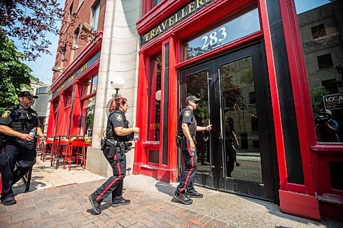 MIKAELA MACKENZIE / FREE PRESS

Foot patrol officers Stephen Desrochers (left), Vivian Smith, and John Middleton (who are part of the Violent Crime Retail Theft Initiative) walk through Old Market Square in the Exchange District on Wednesday, July 10, 2024. 

For Chris story.

