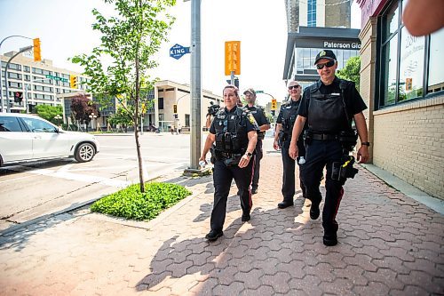 MIKAELA MACKENZIE / FREE PRESS

Foot patrol officers Vivian Smith (left), Stephen Desrochers, Todd Martens, and John Middleton (who are part of the Violent Crime Retail Theft Initiative) walk through Old Market Square in the Exchange District on Wednesday, July 10, 2024. 

For Chris story.

