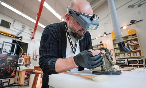 Ruth Bonneville / Free Press

ent - Behind the Scenes - Vitaliy Yatsevych

Photo of Vitaliy Yatsevych,  WAG-Qaumajuq Conservator, at the Winnipeg Art Gallery.

Vitaliy Yatsevych is WAG-Qaumajuq Conservator. His job is to care for and restore artworks to their former glory. 

He recently embarked on one of the biggest restoration projects of his career: Kim Adams Earth Wagons, which is composed of teeny tiny model train parts. 

For feature on him and his work as part of a new Arts &amp; Life series called Behind the Scenes,  Photos  of him with Earth Wagons still on display and working behind the scenes on works.  


Story by Jen Zoratti 

July 10th,  2024

