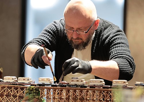 Ruth Bonneville / Free Press

ent - Behind the Scenes - Vitaliy Yatsevych

Photo of Vitaliy Yatsevych,  WAG-Qaumajuq Conservator, at the Winnipeg Art Gallery.

Vitaliy Yatsevych is WAG-Qaumajuq Conservator. His job is to care for and restore artworks to their former glory. 

He recently embarked on one of the biggest restoration projects of his career: Kim Adams Earth Wagons, which is composed of teeny tiny model train parts. 

For feature on him and his work as part of a new Arts &amp; Life series called Behind the Scenes,  Photos  of him with Earth Wagons still on display and working behind the scenes on works.  


Story by Jen Zoratti 

July 10th,  2024

