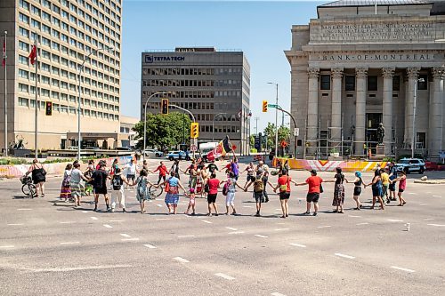 BROOK JONES / FREE PRESS
A round dance takes place at the intersection of Portage Avenue and Main Street in Winnipeg, Man., on the afternoon of Thursday, July 11, 2024. The round dance was organized following the announcement that a judge ruled serial killer Jeremy Anthony Michael Skibicki is criminally responsible for slaying four indigenous women in Winnipeg in early 2022.