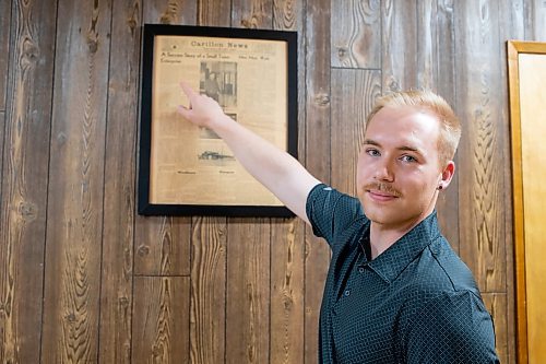 BROOK JONES / FREE PRESS
Dylan Bobrowski points to a Carillon News article about Imperial Steel which is featured on the wall at Imperial Steel at 901 Century St., in Winnipeg, Man., Thursday, July 11, 2024. The second floor offices are all original 1950s wood panelling.