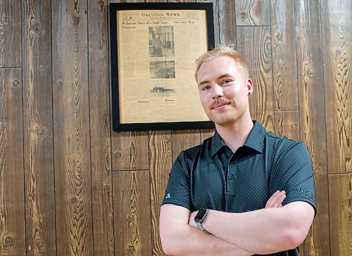 BROOK JONES / FREE PRESS
Dylan Bobrowski stands in front of a Carillon News article about Imperial Steel which is featured on the wall at Imperial Steel at 901 Century St., in Winnipeg, Man., Thursday, July 11, 2024. The second floor offices are all original 1950s wood panelling.