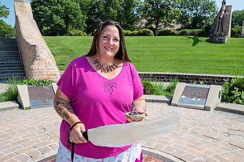 BROOK JONES / FREE PRESS
Jaime Grasby who is an indigenous story teller and knowledge keeper holds a feather fan and a smudging shell as she is pictured at the Oodena Celebration Circle at The Forks in Winnipeg, Man., Thursday, July 11, 2024.