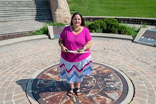 BROOK JONES / FREE PRESS
Jaime Grasby who is an indigenous story teller and knowledge keeper holds a feather fan and a smudging shell as she is pictured at the Oodena Celebration Circle at The Forks in Winnipeg, Man., Thursday, July 11, 2024.