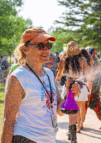 NIC ADAM / FREE PRESS
The 49th edition of the Winnipeg Folk Festival kicks off Thursday night with a music lineup that includes Lucinda Williams and Winnipeg&#x2019;s Roman Clarke.
Winnipeg Folk Fest Audience Services volunteer, Gayle Michalyshyn, cools attendees down with cold water as they enter the festival grounds.
240711 - Thursday, July 11, 2024.

Reporter: Eva Wasney