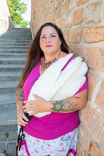 BROOK JONES / FREE PRESS
Jaime Grasby, 43, who is an indigenous story teller and knowledge keeper holds a smuding feather fans as she is pictured at the Oodena Celebration Circle at The Forks in Winnipeg, Man., Thursday, July 11, 2024.