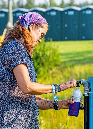 NIC ADAM / FREE PRESS
The 49th edition of the Winnipeg Folk Festival kicks off Thursday night with a music lineup that includes Lucinda Williams and Winnipeg&#x2019;s Roman Clarke.
Folk Fest attendee Kristin Roderick Wilson, from Minneapolis Minnesota, fills her water bottle at one of the many watering stations. It is her 3rd time attending the festival.
240711 - Thursday, July 11, 2024.

Reporter: Eva Wasney