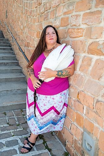 BROOK JONES / FREE PRESS
Jaime Grasby, 43, who is an indigenous story teller and knowledge keeper holds a smuding feather fans as she is pictured at the Oodena Celebration Circle at The Forks in Winnipeg, Man., Thursday, July 11, 2024.