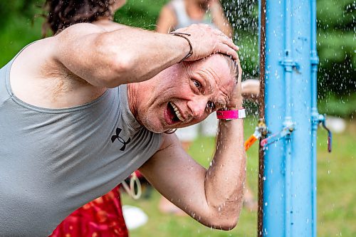 NIC ADAM / FREE PRESS
Chris Marinelli cools off from the heat at one of the cooling stations at the Winnipeg Folk Festival Friday afternoon. It&#x2019;s the Winnipegger&#x2019;s seventh time at the festival.
240712 - Friday, July 12, 2024.

Reporter: ?
