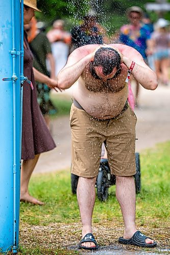 NIC ADAM / FREE PRESS
Eamon Doyle, of San Francisco, cools off from the heat at one of the cooling stations at the Winnipeg Folk Festival Friday afternoon. It&#x2019;s his 3rd time attending the festival in 26 years making it a decennial tradition for him.
240712 - Friday, July 12, 2024.

Reporter: ?
