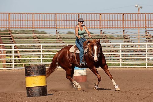 12072024
Tori Colosimo and her running bred quarter horse Sox round a barrel while taking part in an advanced barrel racing clinic led by Shannon Kerr, a horse trainer and barrel racer living in Brazil, at the Austin Stampede grounds on a scorching hot Thursday. Colosimo trains horses as well and is training Sox for his first year competing in barrel racing. (Tim Smith/The Brandon Sun)