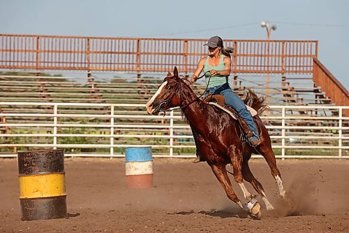 12072024
Tori Colosimo and her running bred quarter horse Sox round a barrel while taking part in an advanced barrel racing clinic led by Shannon Kerr, a horse trainer and barrel racer living in Brazil, at the Austin Stampede grounds on a scorching hot Thursday. Colosimo trains horses as well and is training Sox for his first year competing in barrel racing. (Tim Smith/The Brandon Sun)