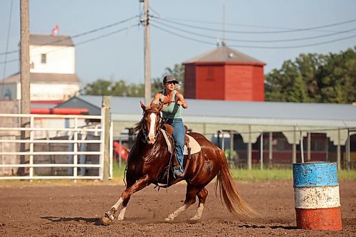 12072024
Tori Colosimo and her running bred quarter horse Sox round a barrel while taking part in an advanced barrel racing clinic led by Shannon Kerr, a horse trainer and barrel racer living in Brazil, at the Austin Stampede grounds on a scorching hot Thursday. Colosimo trains horses as well and is training Sox for his first year competing in barrel racing. (Tim Smith/The Brandon Sun)