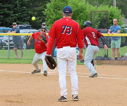 Borderline Legends first baseman Craig Zamzow stretches to catch the ball on a close play to put out Onanole Sporty&#x2019;s Originals batter Chris Hanson (8) under the watchful eye of pitcher Terry Peppler (73) during the inaugural 50-plus Softball Manitoba masters championship in Onanole on Sunday afternoon. The Originals earned a hard-fought 8-7 victory. (Perry Bergson/The Brandon Sun)
July 14, 2024