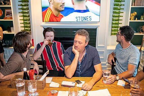 BROOK JONES / FREE PRESS
Joel Boulet (second from far right) reflects on the Euro Cup final between England and Spain. Boulet watched the match with his sons Joe (left) and Sam (second from far left) and their friend Trevor Martin on the TVs at the Elephant & Castle in Winnipeg, Man., Sunday, July 14, 2024.