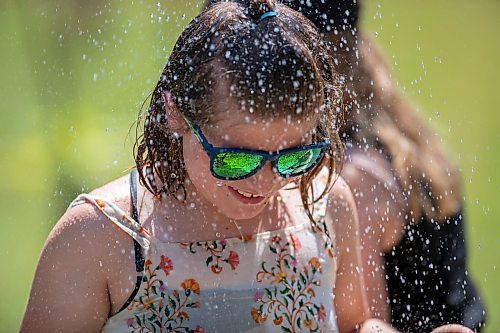 BROOK JONES / FREE PRESS
Folk Fest goer Tegan McCaul, 9, who is from Thunder Bay, Ont., keeps cool by taking advantage of the public shower at a cooling station at the 49th Winnipeg Folk Festival at Birds Hill Provincial Park in Man., Sunday, July 14, 2024. It was McCaul's third Folk Fest.