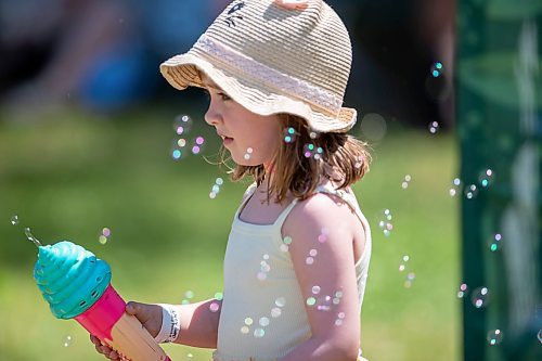 BROOK JONES / FREE PRESS
Folk Fest goer Georgia Betker having fun with her ice cream cone mini bubble blower while hanging out at the Snowberry Field stage area at the 49th Winnipeg Folk Festival at Birds Hill Provincial Park in Man., Sunday, July 14, 2024. It was the four-year-old second time attending Folk Fest.