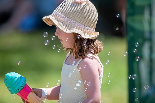 BROOK JONES / FREE PRESS
Folk Fest goer Georgia Betker having fun with her ice cream cone mini bubble blower while hanging out at the Snowberry Field stage area at the 49th Winnipeg Folk Festival at Birds Hill Provincial Park in Man., Sunday, July 14, 2024. It was the four-year-old second time attending Folk Fest.