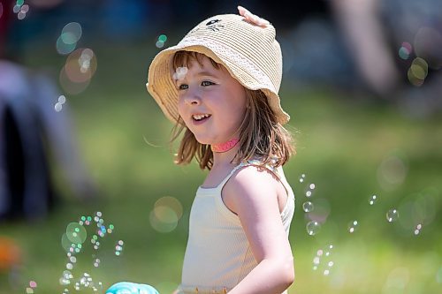 BROOK JONES / FREE PRESS
Folk Fest goer Georgia Betker having fun with her ice cream cone mini bubble blower while hanging out at the Snowberry Field stage area at the 49th Winnipeg Folk Festival at Birds Hill Provincial Park in Man., Sunday, July 14, 2024. It was the four-year-old second time attending Folk Fest.