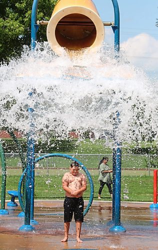 Nine-year-old Rayson from Regina is about to get drenched by the contents of a huge bucket of water at Brandon's Rideau Spray Park on a warm and sunny Monday afternoon. (Matt Goerzen/The Brandon Sun)