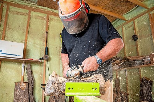 NIC ADAM / FREE PRESS
Sean Philips, 52, makes one-of-a-kind woodwork sculptures and pieces in the garage of his home from salvaged wood sourced here in MB.
Sean Philips cares a section of log into a bowl in his garage studio on Monday afternoon.
240715 - Monday, July 15, 2024.

Reporter: