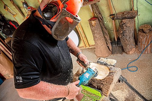 NIC ADAM / FREE PRESS
Sean Philips, 52, makes one-of-a-kind woodwork sculptures and pieces in the garage of his home from salvaged wood sourced here in MB.
Sean Philips cares a section of log into a bowl in his garage studio on Monday afternoon.
240715 - Monday, July 15, 2024.

Reporter: