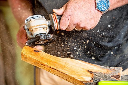 NIC ADAM / FREE PRESS
Sean Philips, 52, makes one-of-a-kind woodwork sculptures and pieces in the garage of his home from salvaged wood sourced here in MB.
Sean Philips cares a section of log into a bowl in his garage studio on Monday afternoon.
240715 - Monday, July 15, 2024.

Reporter: