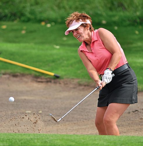 Golfer Denise Gallant chips her ball out of a sand trap during an outing at the Shilo Country Club. (Photos by Jules Xavier/The Brandon Sun)